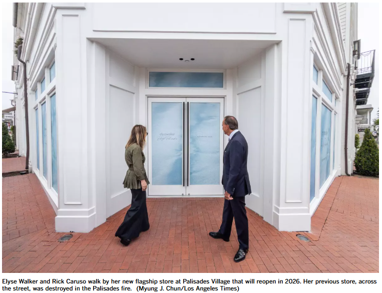 Elyse Walker and Rick Caruso walk by her new flagship store at Palisades Village that will reopen in 2026. Her previous store, across the street, was destroyed in the Palisades fire. (Myung J. Chun/Los Angeles Times)